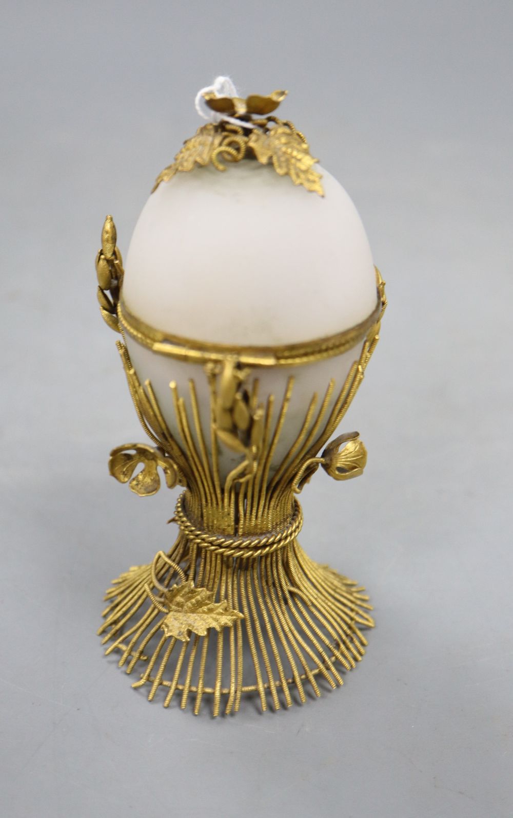 An opaque glass gilt metal egg-shaped necessaire